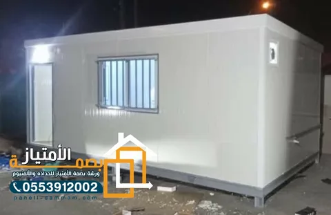 غرفة ساندوتش بانل بيضاء بنافذة مشبكة بعد التركيب ليلاً في القطيف